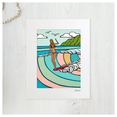 Tropical art matted print by Hawaii artist Heather Brown featuring a surf girl on a red longboard riding a pastel colored wave 
