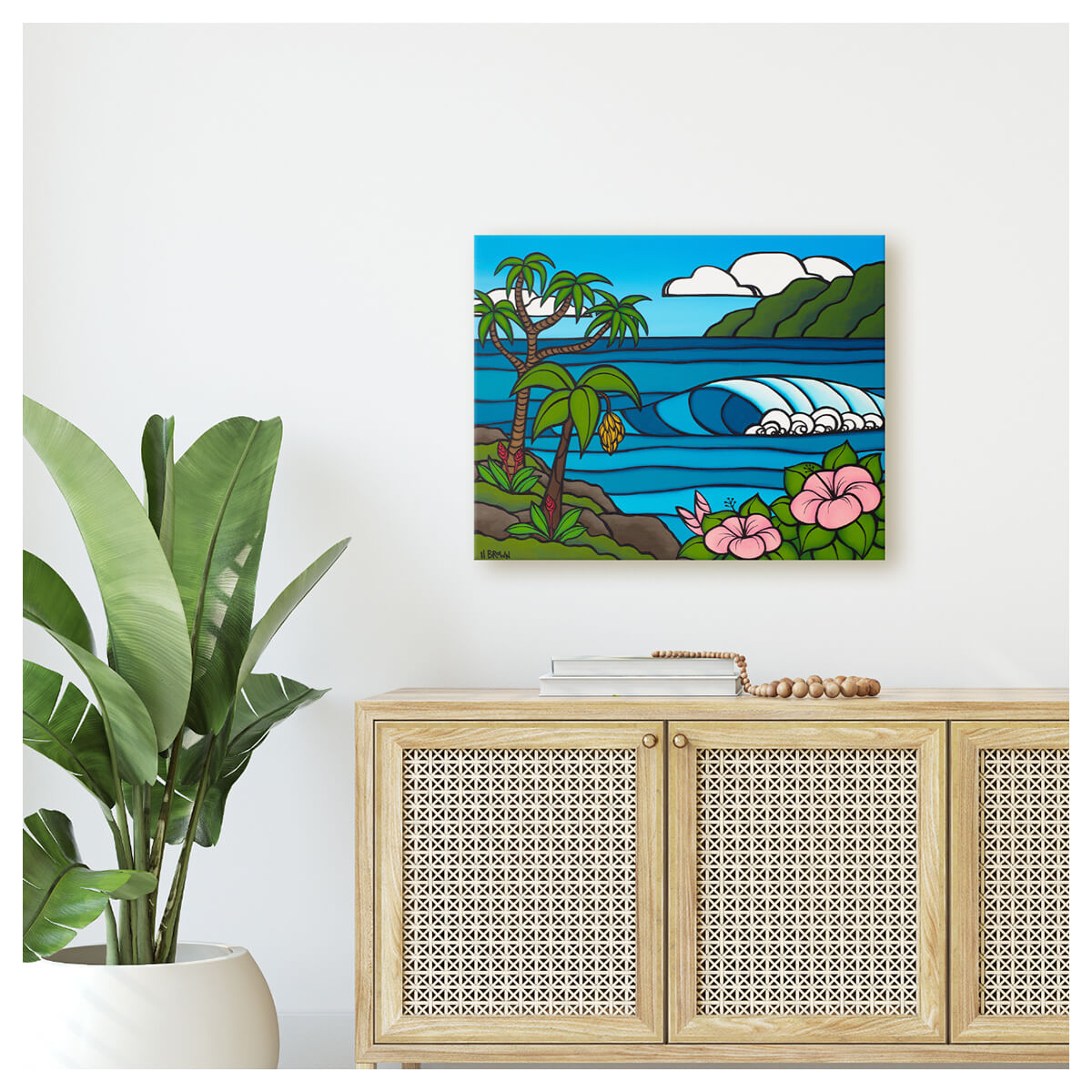 Colorful canvas artwork in Coastal Modern home by Kauai artist Heather Brown featuring a serene Hawaii seascape with a cresting wave, framed by pink hibiscus flowers and a banana tree with green mountains in the distance.