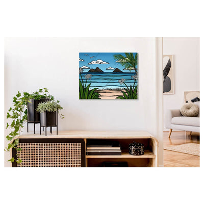 A metal art print featuring a swaying palm tree, tropical flowers, gorgeous blue waves, volcanos, and birds in flight by Hawaii surf artist Heather Brown