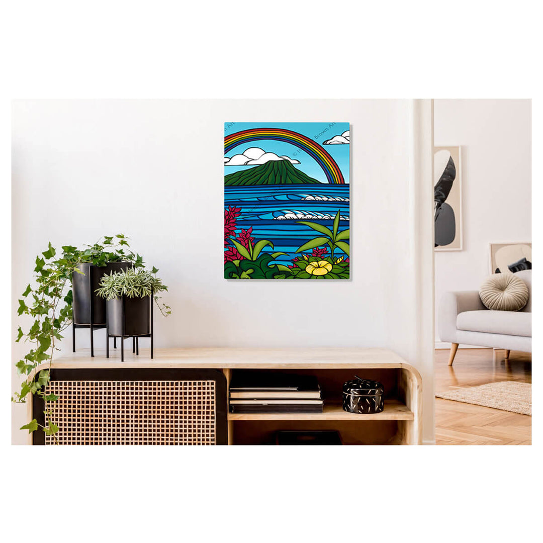 A metal art print featuring a rainbow, tropical flowers, rolling blue waves, and Honolulu's iconic landmark, Diamond Head by Hawaii surf artist Heather Brown