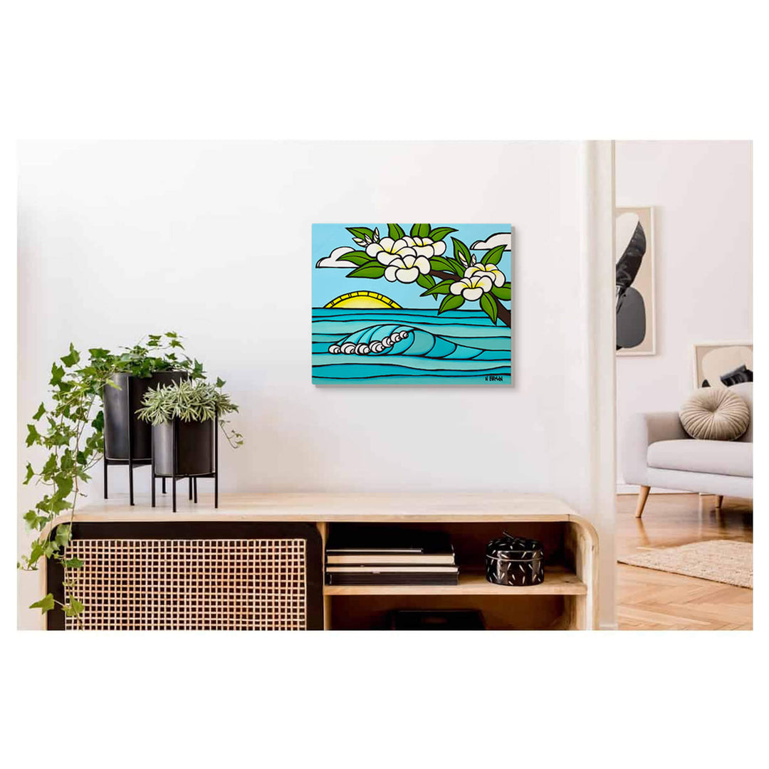 A metal art print of a sunrise with rolling waves and plumeria flowers by Hawaii surf artist Heather Brown