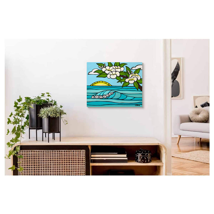 A metal art print of a sunrise with rolling waves and plumeria flowers by Hawaii surf artist Heather Brown