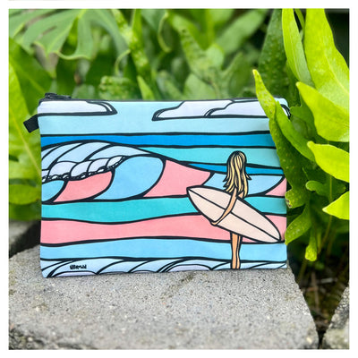 a beach clutch featuring a surf girl heading to the beach in pastel colors by Hawaii surf artist Heather Brown