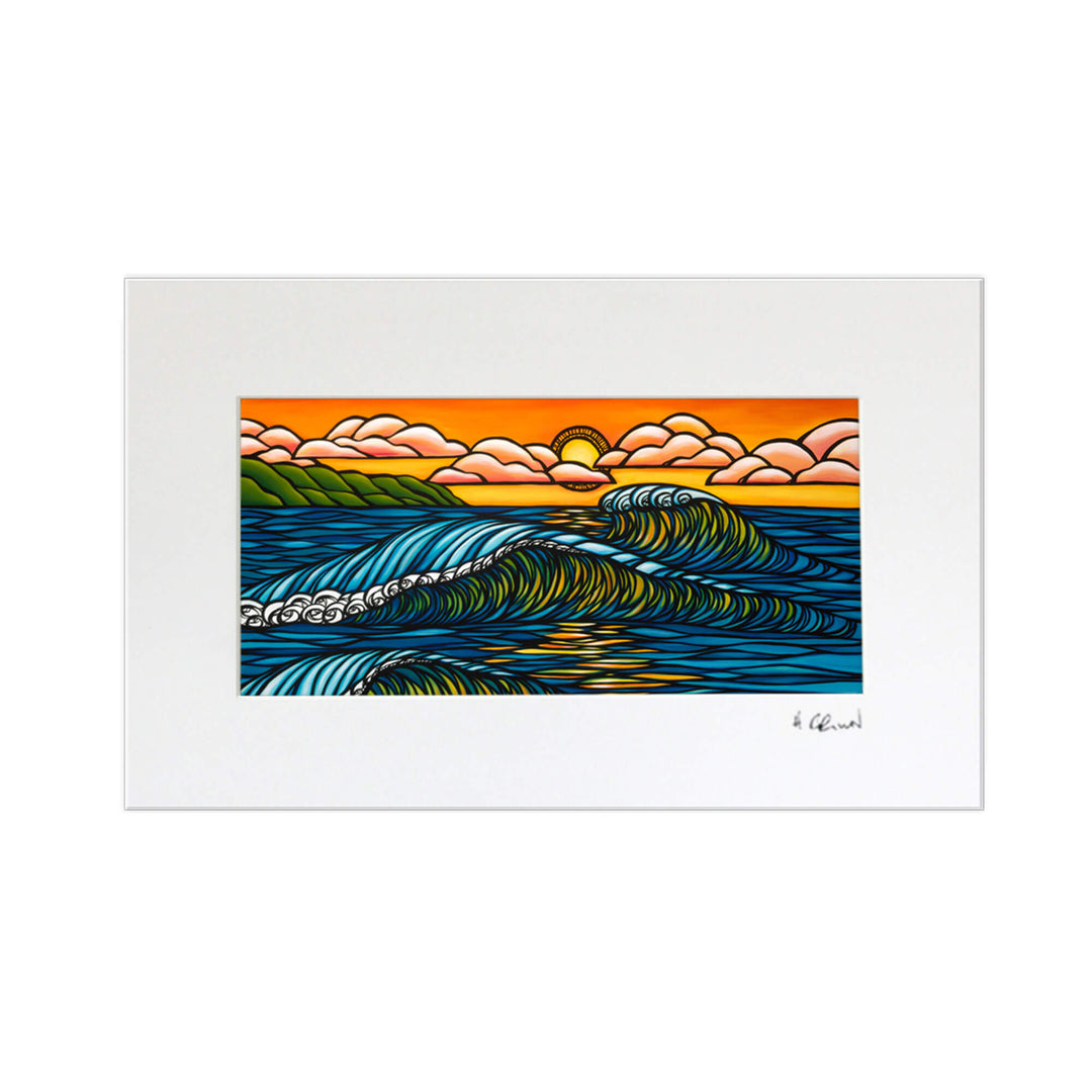 A matted art print featuring the sun sinking below the horizon at Haleiwa harbor, illuminating the rolling waves by Hawaii surf artist Heather Brown