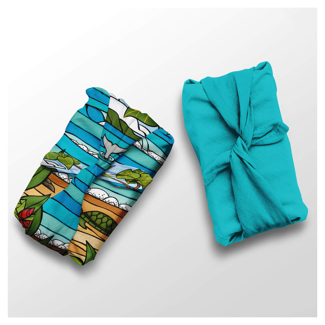 Seascape with sea creatures and a solid teal colored furoshiki wrapping cloths by Hawaii surf artist Heather Brown