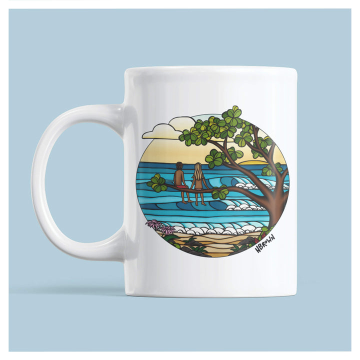 A white ceramic featuring a couple on a tree enjoying the beautiful sunset by Hawaii surf artist Heather Brown