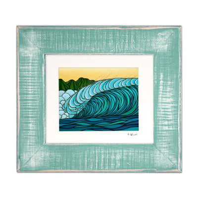 A framed matted art print featuring waves through bold blues and distant green mountains by Hawaii surf artist Heather Brown