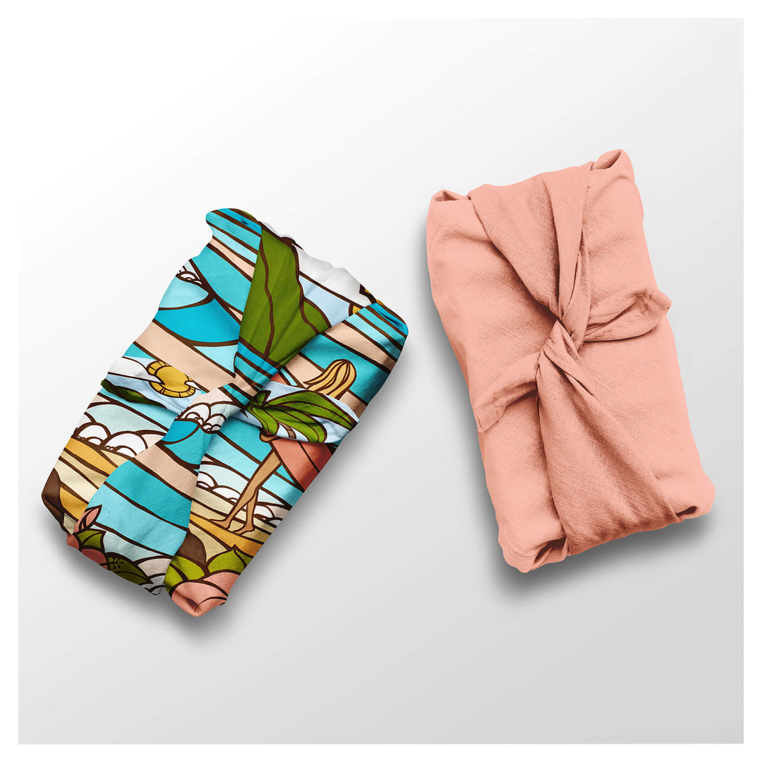 Pastel colored seascape with a female surfer and a solid coral orange colored furoshiki cloth by Hawaii surf artist Heather Brown