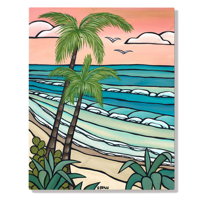 A metal art print featuring rolling waves meeting a secluded beach against a pink-hued by Hawaii surf artist Heather Brown