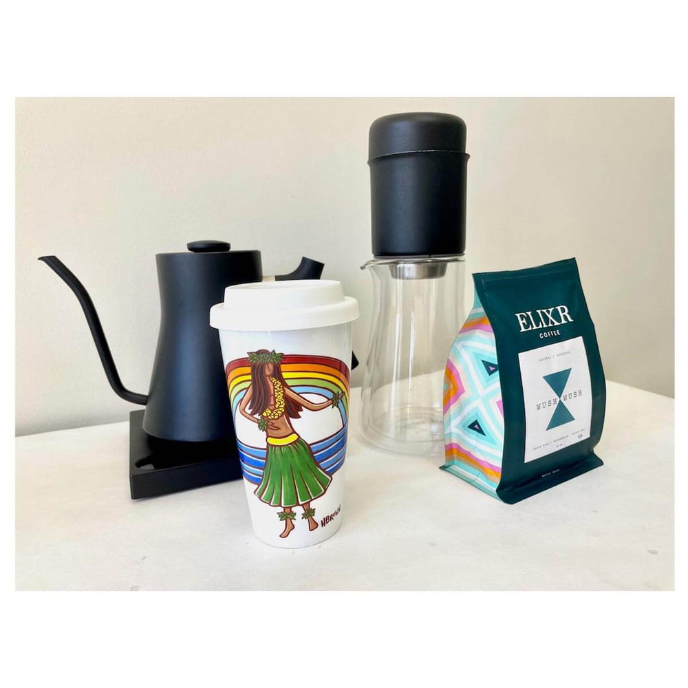 White ceramic coffee tumbler with Hawaiian hula and rainbow art by Oahu artist Heather Brown